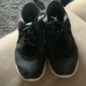 Woman’s black Nike shoes
